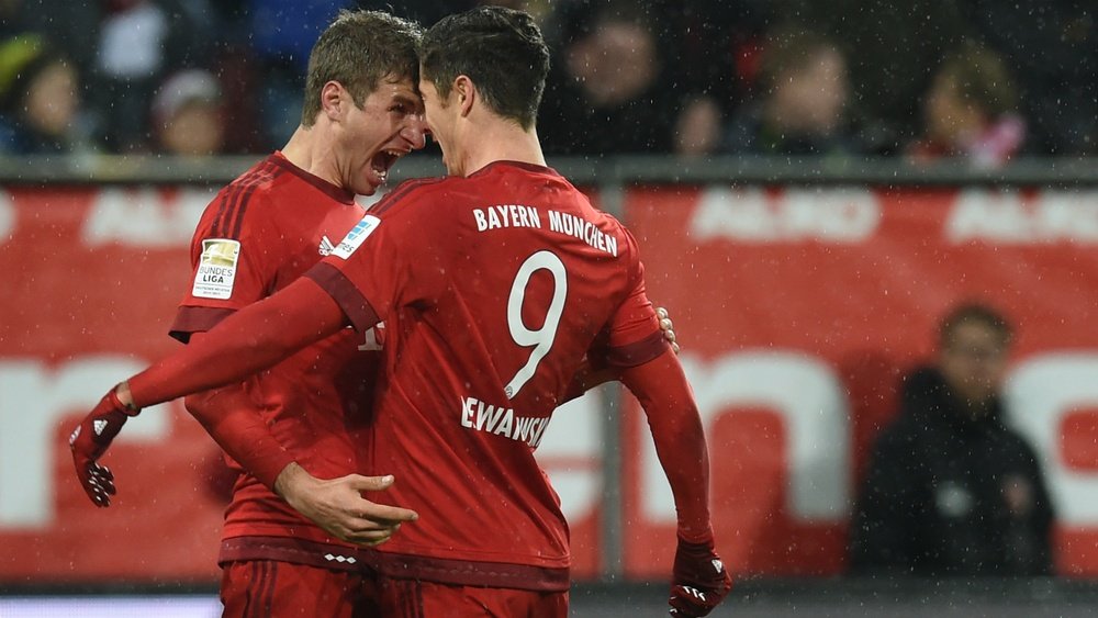 Muller (left) celebrating with Lewandowski. Goal