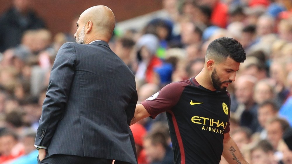 Guardiola (L) shakes Aguero's hand as he leaves the pitch. Goal