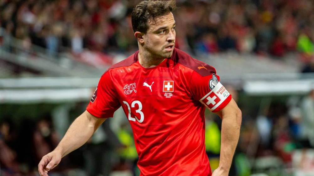 A fan came onto the pitch to put a provocative jacket on Xherdan Shaqiri. GOAL